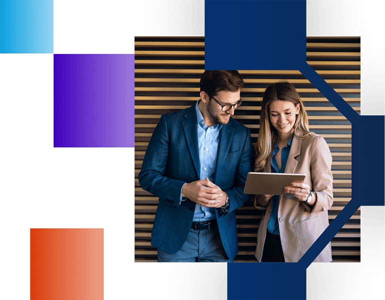 Businessman and woman standing next to each other and looking at a tablet