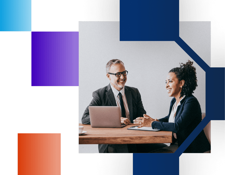 Man and woman sitting at a conference room table 