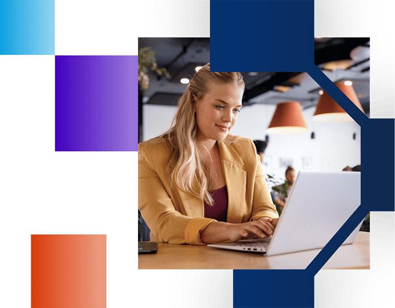 Young woman in a blazer working on a laptop