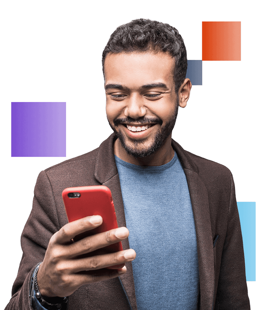 Smiling man in a blue shirt and brown blazer holding a red smartphone